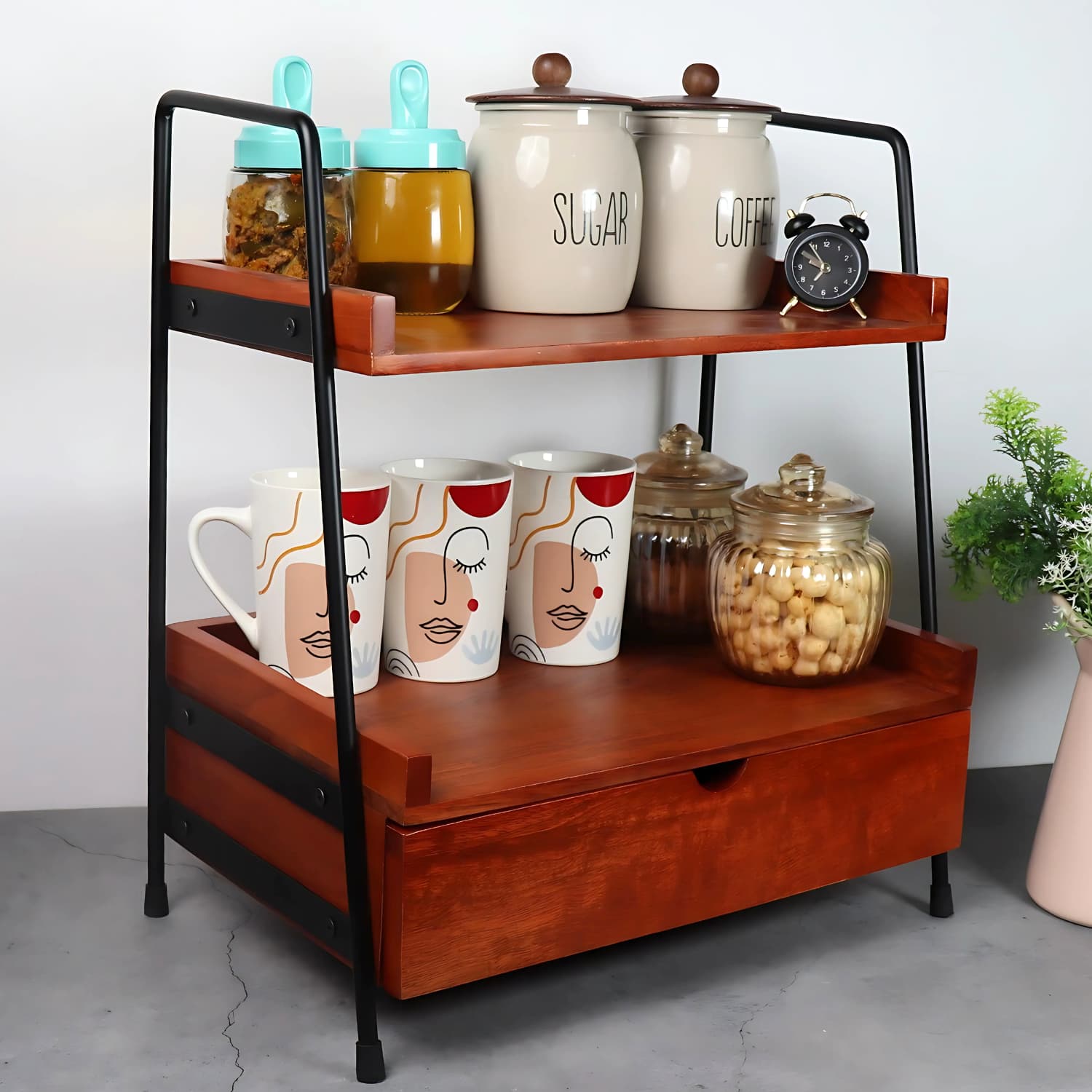 Loosebucket's Xylostow Premium Woden kitchen organizer displaying kitchen jar ,coffee mug and small table watch on it